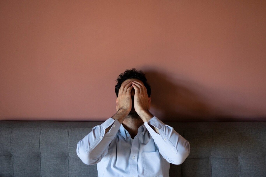 get rid of anxiety - Frustrated man on couch
