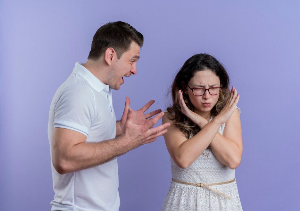 Young couple man and woman quarreling man shouting on his girlfriend - Attachment Style in Relationships