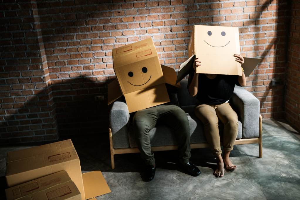 Couple sitting together with heads boxes - Psychological and Emotional Impact of a Depression Room