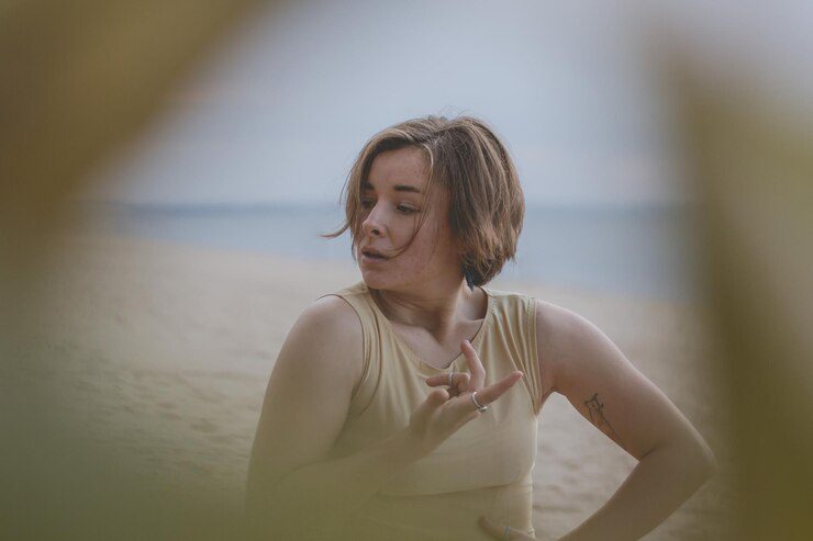 Woman looking away while standing on beach