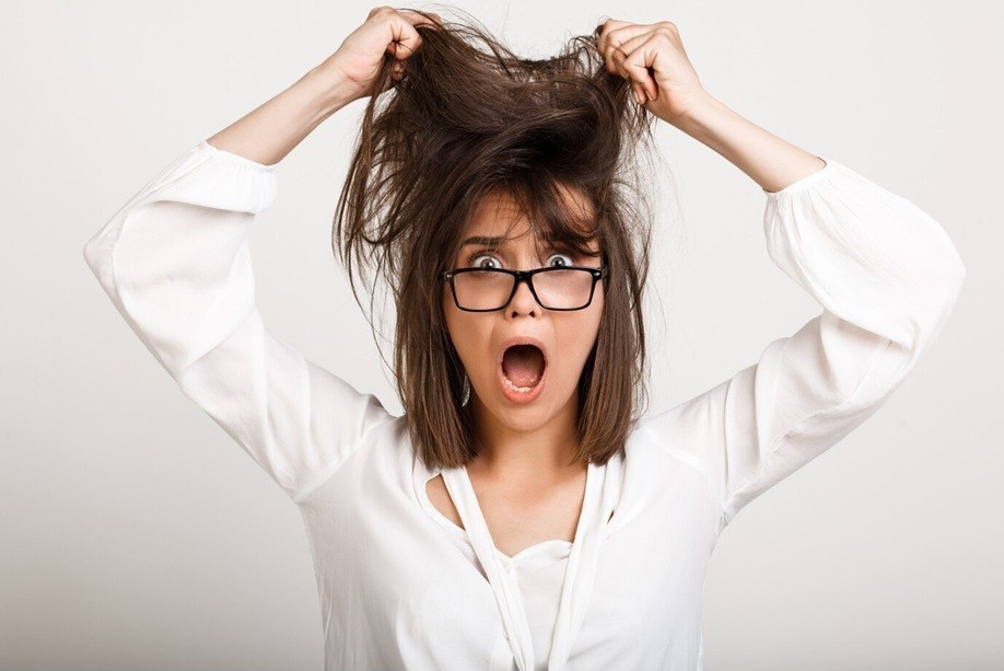 how many strands of hair do you lose a day - Woman in panic tousle hair