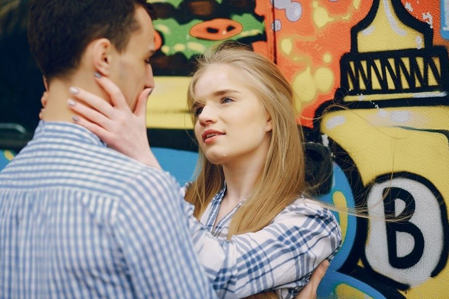 what does love language mean - two people standing at the wall with a lot of painting