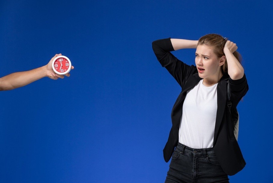 intermittent explosive disorder - female student in black jacket wearing backpack on light-blue wall