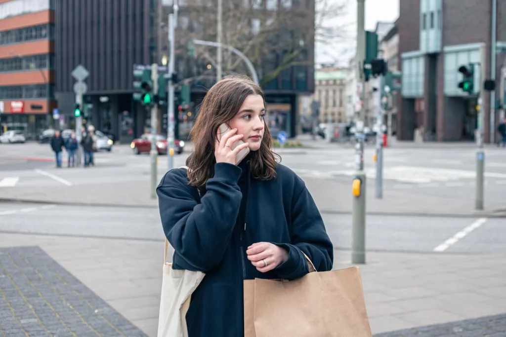 A young woman in the city on the street with a package shopping