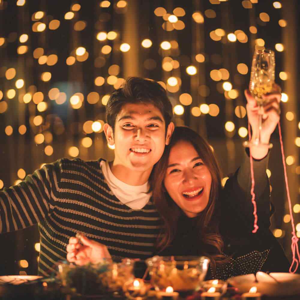 Two people at a festive table, reflecting on marriage success or failure in NYC.