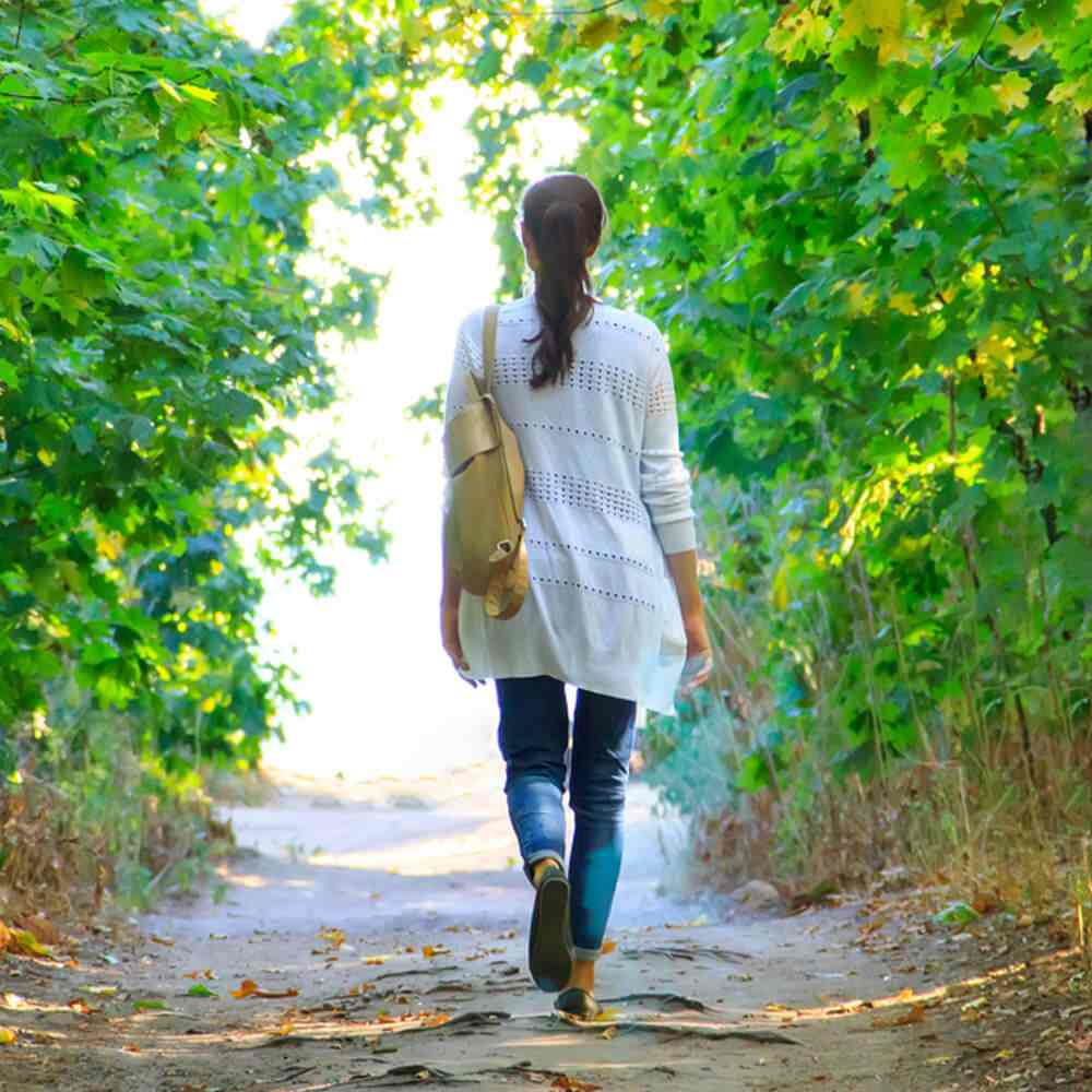 Woman walking on leafy path, knowing when to leave a person with mental illness in NYC.