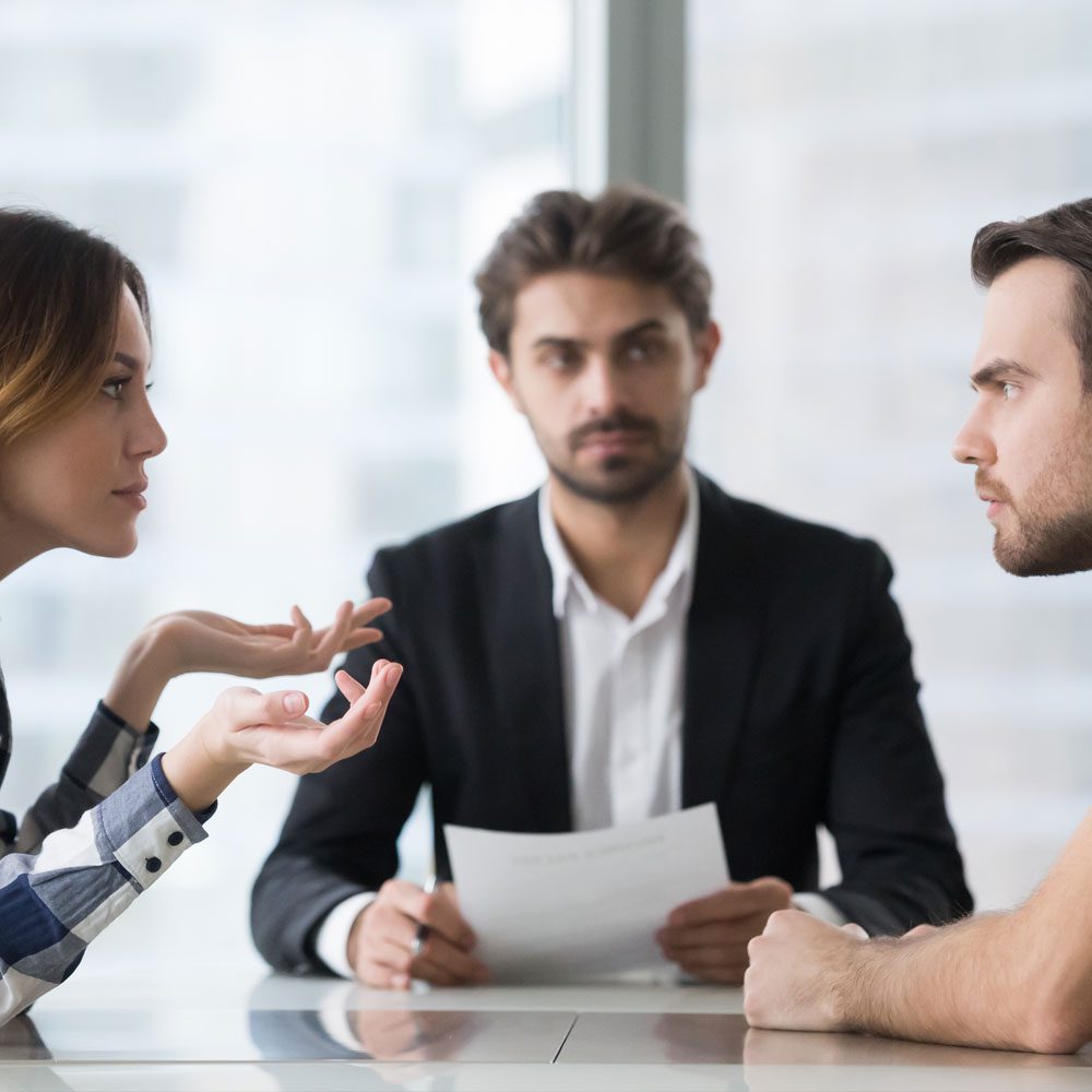 Three people in a meeting, navigating realistic relationship resolutions in digital age.