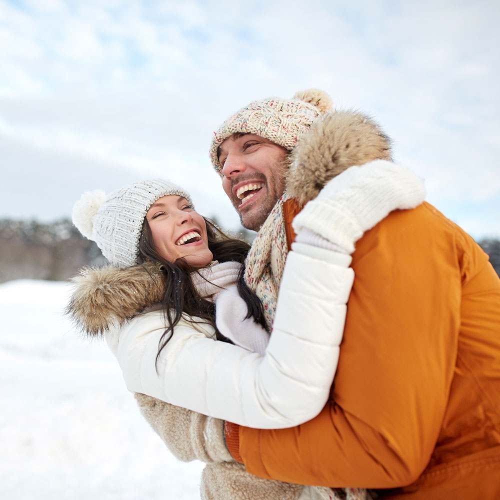 Two people embracing in winter attire, celebrating love and self-love in NYC - Uncover Counseling.
