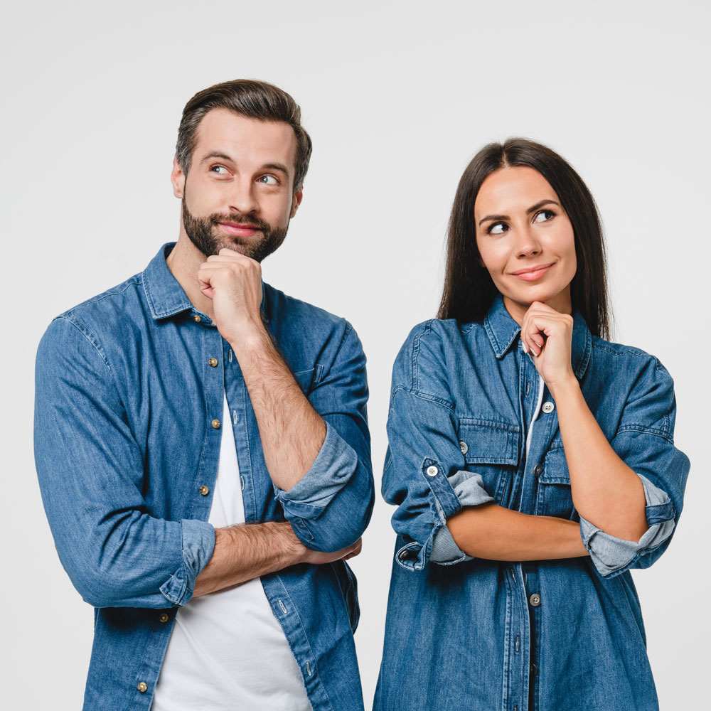 Two people in denim standing with folded arms, exploring conscious dating in NYC.