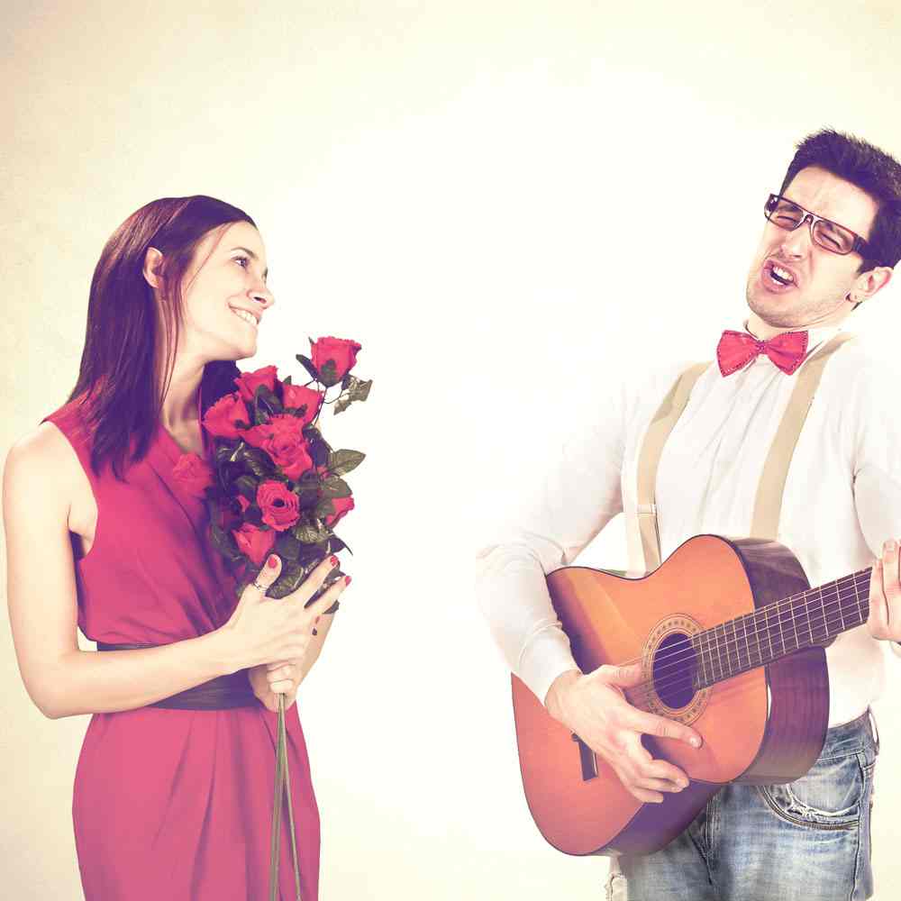 Woman in a red dress with roses and a man with a guitar, navigating Valentine's Day in NYC.