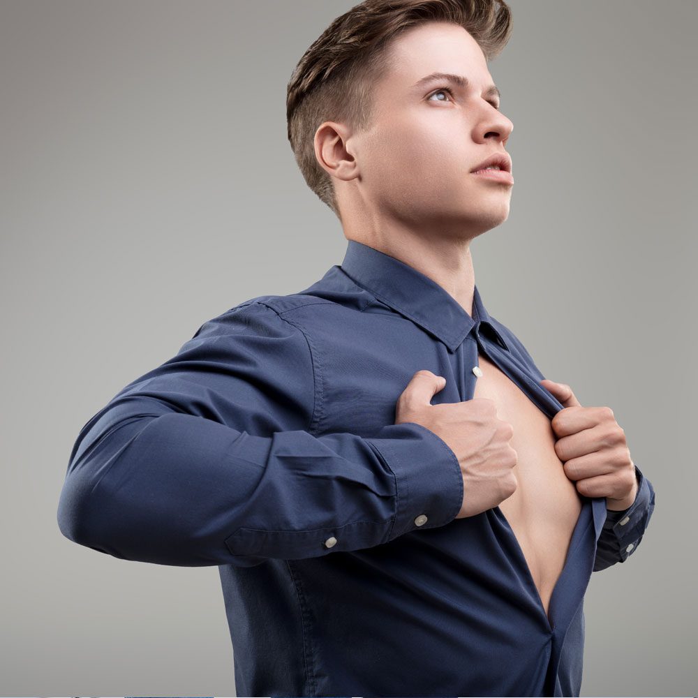 Person in blue shirt revealing chest, exploring the anger iceberg in NYC - Uncover Counseling.
