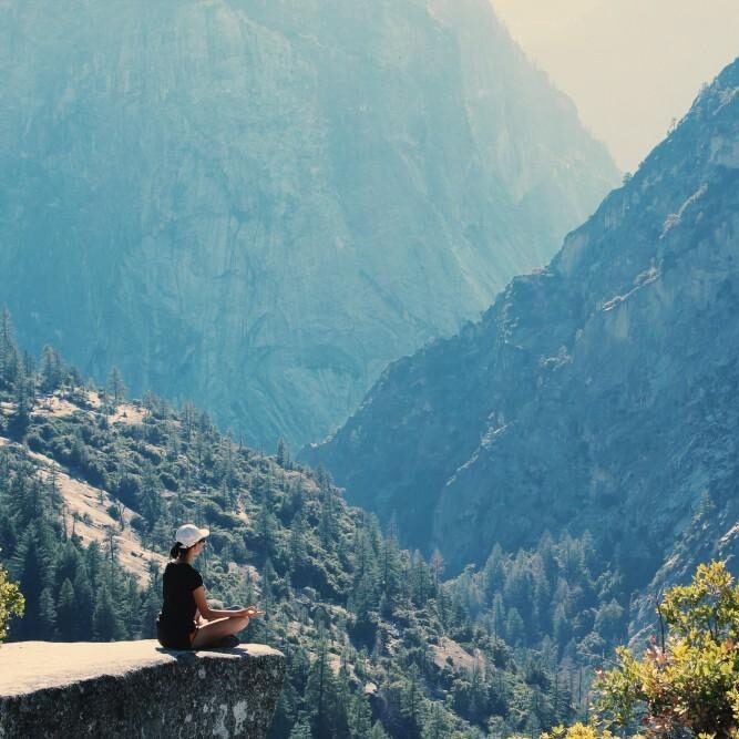 Mountains and female performing Yoga