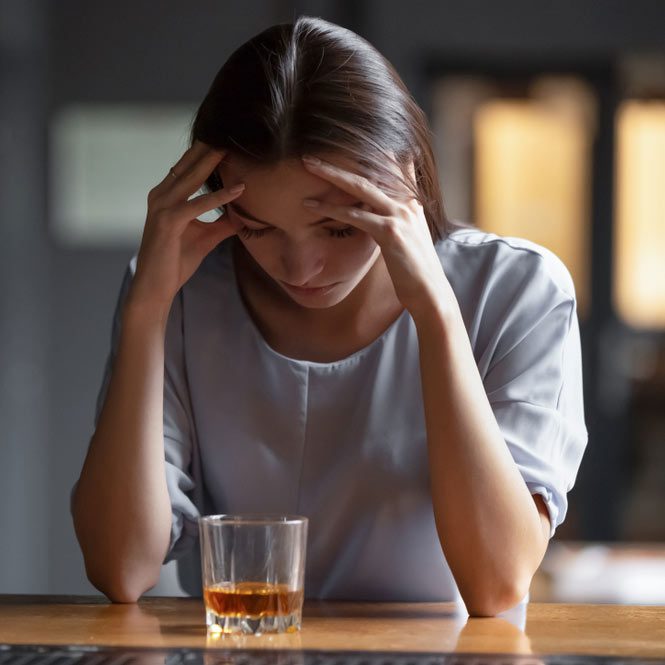 Depressed sad young addicted woman feeling bad drinking