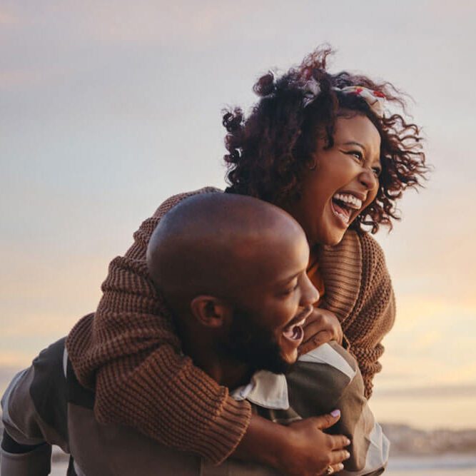 couple, travel and beach fun while laughing on sunset nature adventure and summer vacation