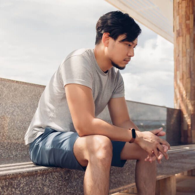 Lonely Asian man sitting in the hut by the sea