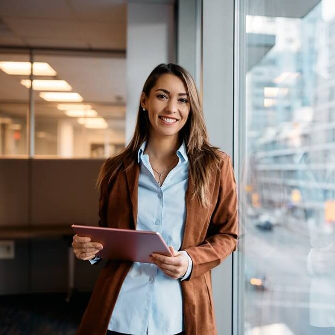 Young happy woman using digital tablet