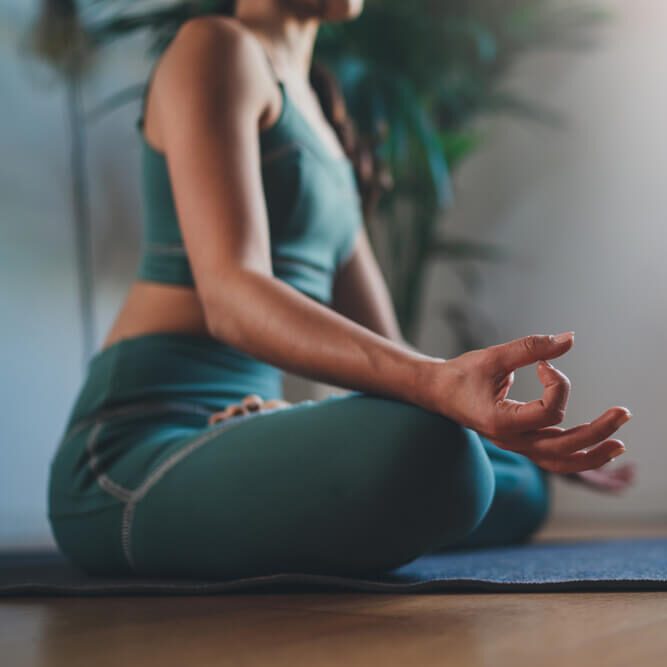 young woman practicing yoga in the morning sitting straight