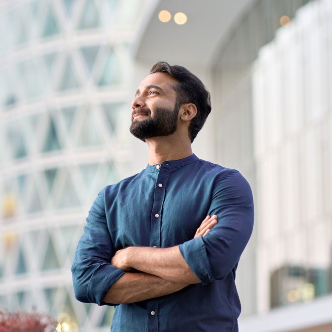Business man executive standing in modern big city looking and dreaming of future business success