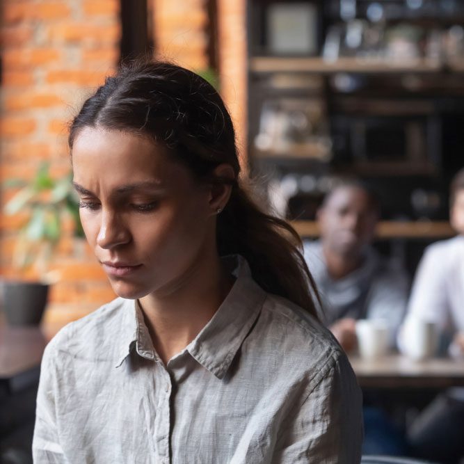 Upset mixed race woman suffering from bullying