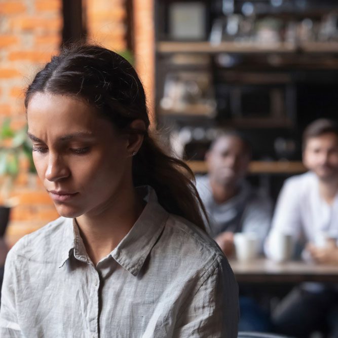 Upset mixed race woman suffering from bullying, discrimination