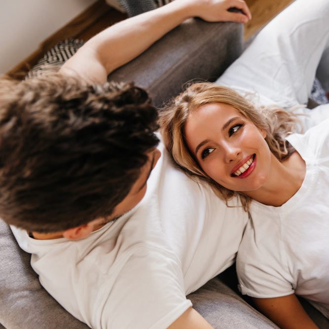 Sweet photo from above with couple holding hands at apartments.