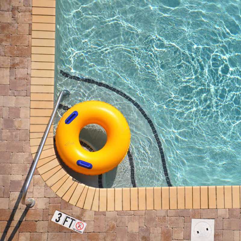 Orange lifebuoy floating in a pool, addressing coping with holiday blues in NYC.