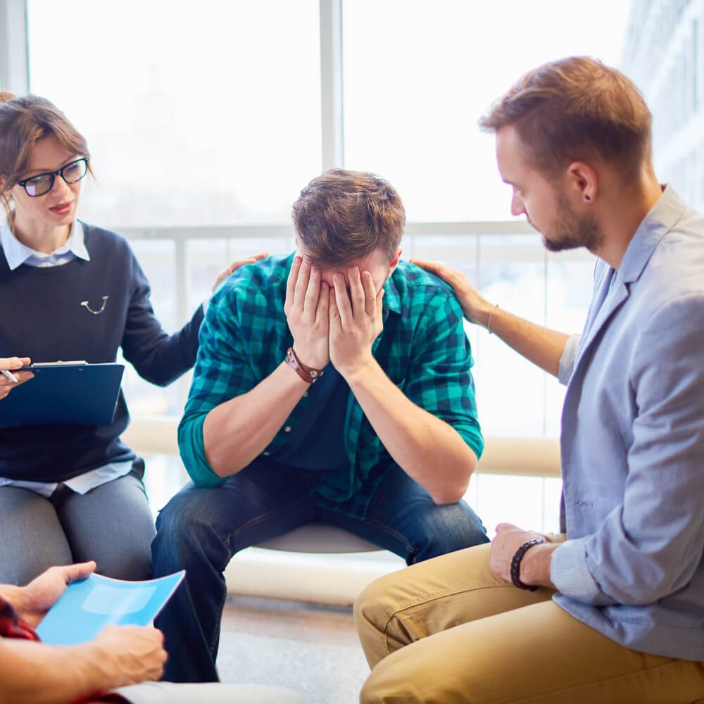 Group meeting with comfort and clipboard, highlighting grief counseling in NYC.