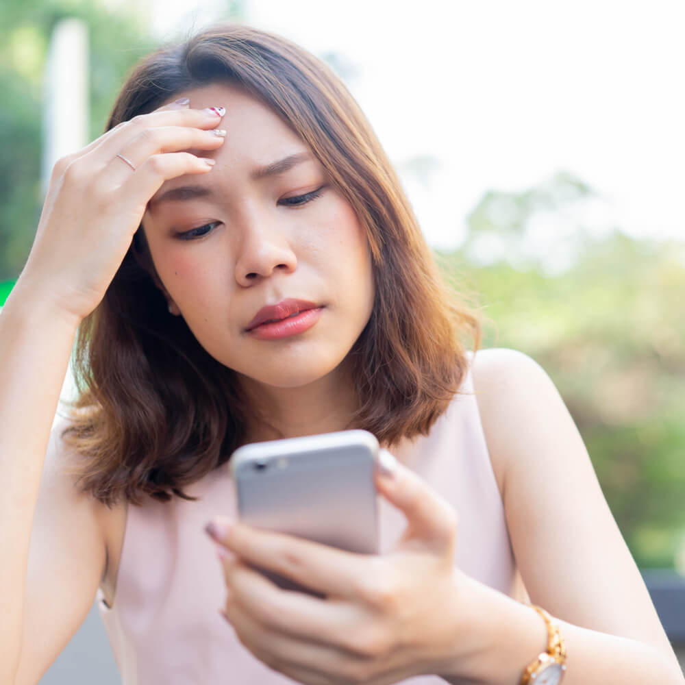Person holding a smartphone, exploring social media’s effect on mental health.