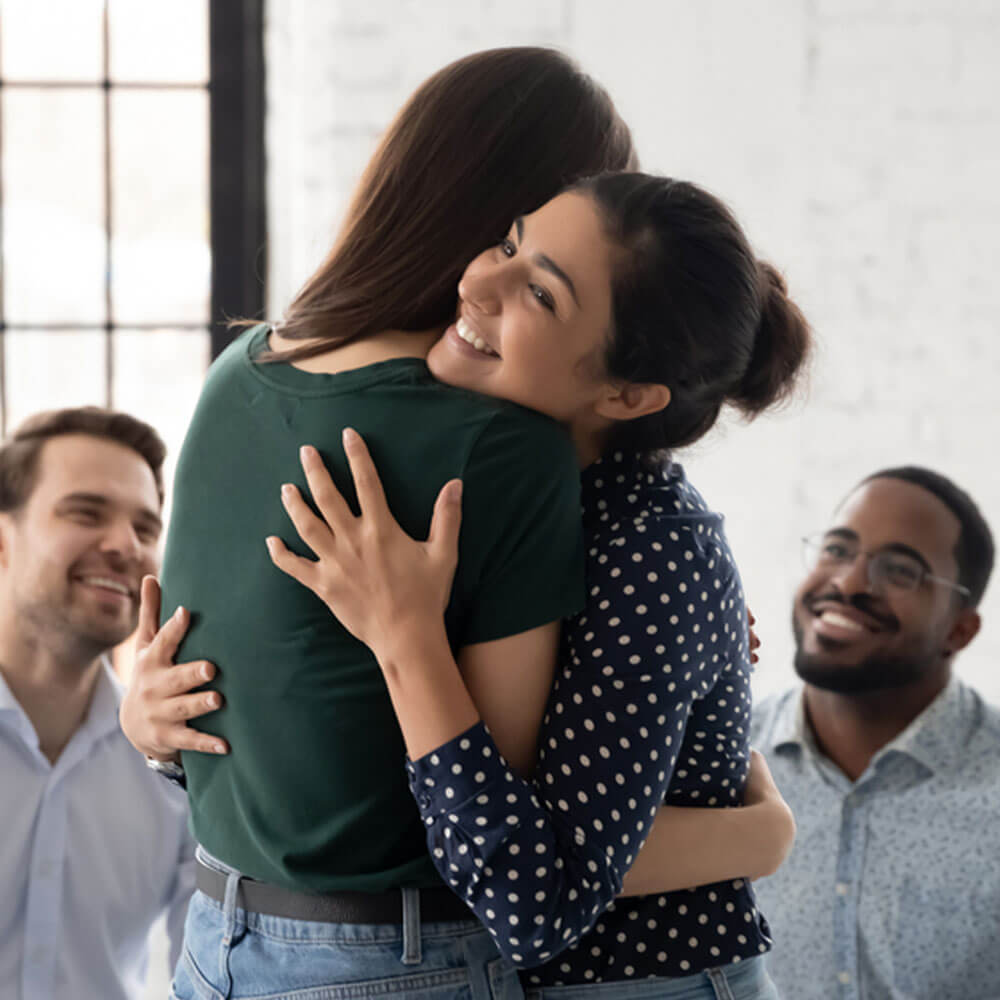 Two people embracing, highlighting the importance of mental health training for employees in NYC.
