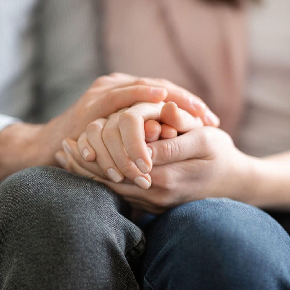 Two people holding hands, showcasing the power of forgiveness therapy in NYC.