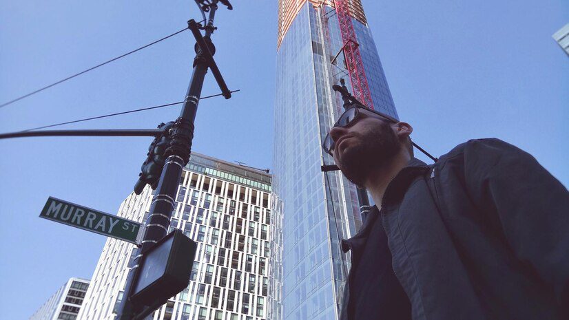 Low angle view of man standing against building in New York City