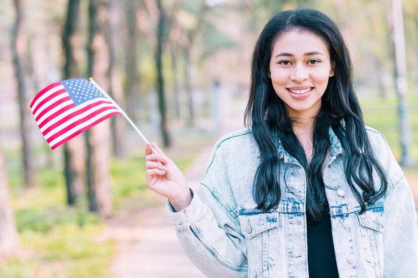 a woman holding a american flag - asian american mental health