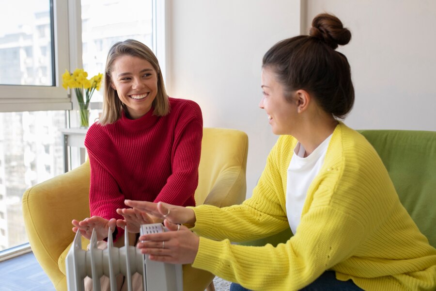 therapy for women - two women sitting on a couch looking and smiling to each other