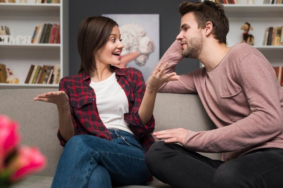 how to communicate in a relationship - two person sitting on the couch while talking