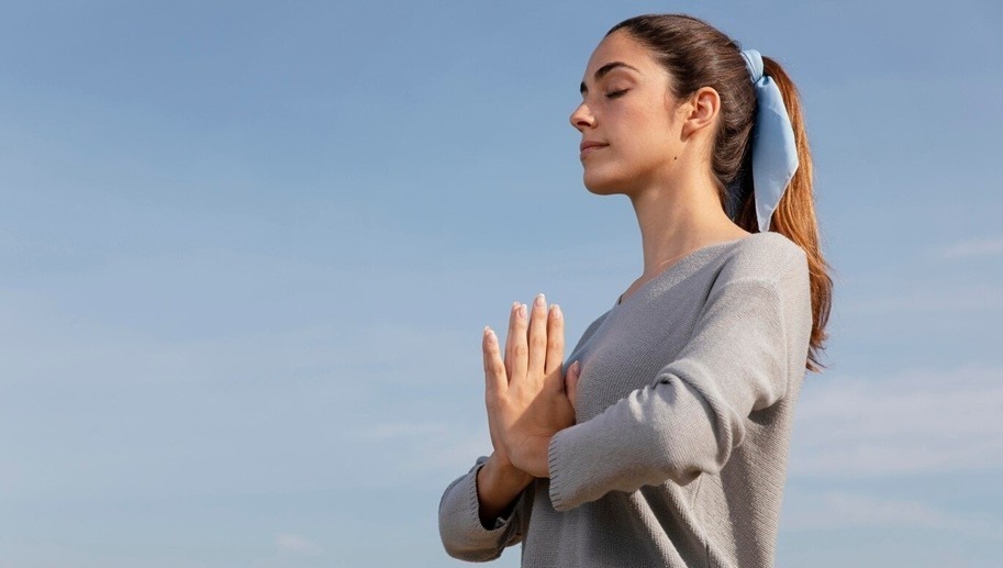 self-awareness - a woman meditating in nature