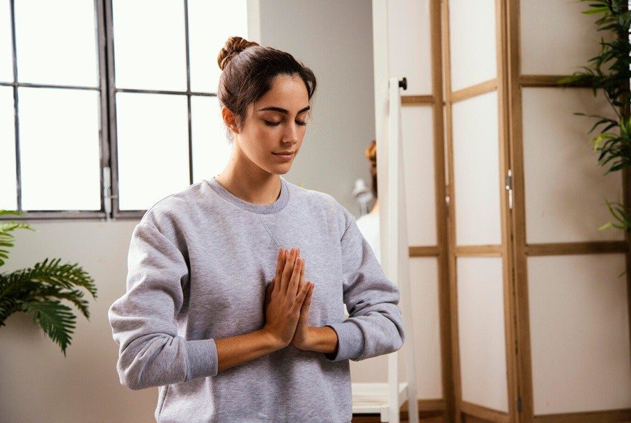 self awareness - young woman doing yoga at home