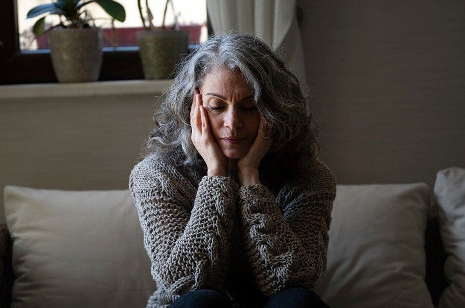 anxiety in older adults - sad elder woman on the sofa