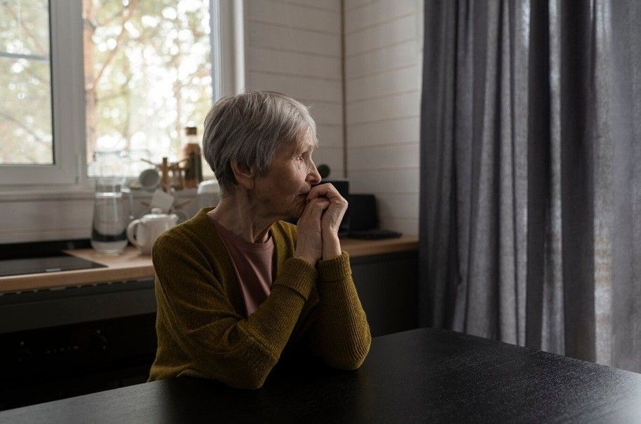 anxiety in older adults - senior woman sitting at table